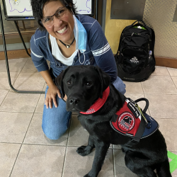 Woman with a service dog at WLM+P