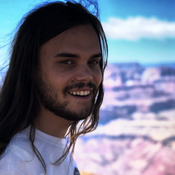 Headshot of a man in front of the grand canyon