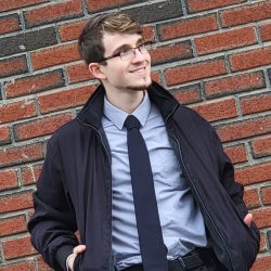 man in front of brick wall