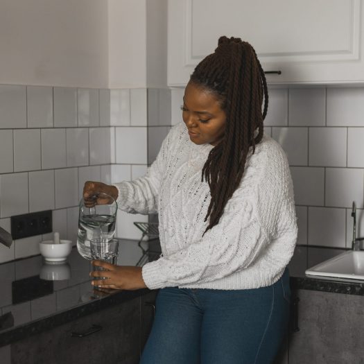 Woman pouring a glass of water